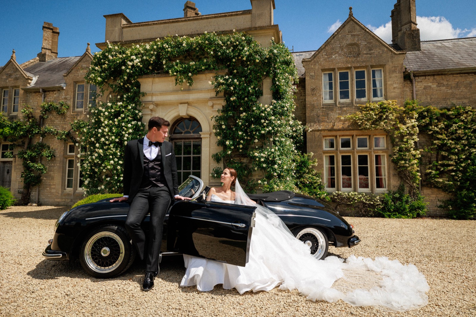 The couple by a vintage car at the end of the day